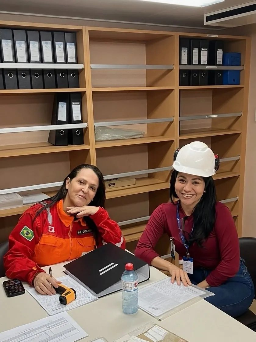 Two members of the Rose Wind operations team reviewing documents together